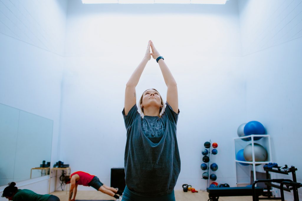 Young woman doing yoga in a gym setting