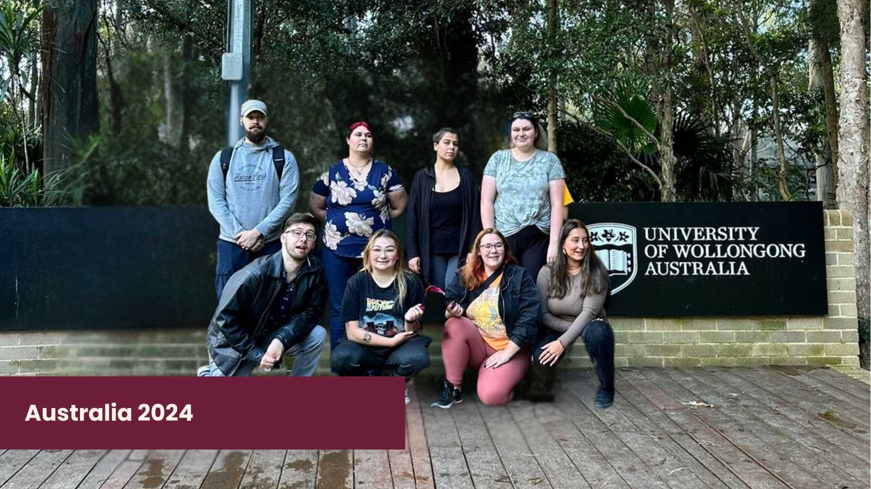 Eight students pose in front of a University of Wollongong Australia sign, surrounded by trees. A "Cambrian College Global Skills Opportunity" banner at the bottom left reads "Australia 2024.