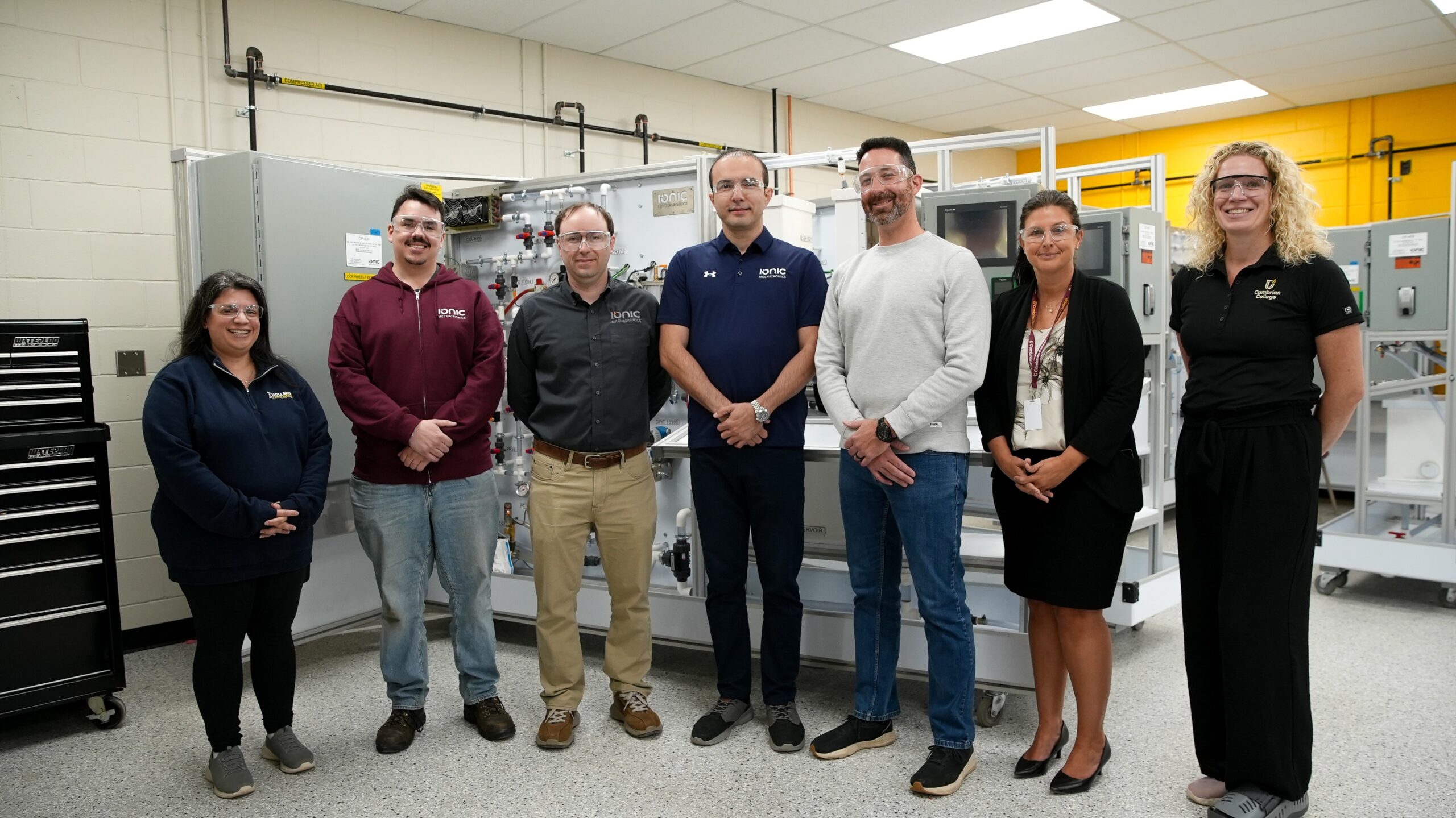 Members of IONIC Mechatronics and Cambrian College stand in front of new engineering workstations built for Cambrian by IONIC.